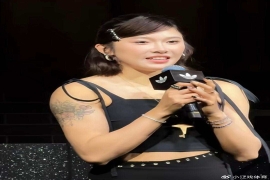 全国田径锦标赛上成功卫冕女子100米栏冠军的吴艳妮，在上海参加活动时因一张照片引发争议。